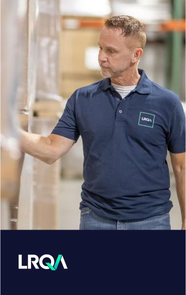 Man in blue polo shirt with LRQA logo in a warehouse, with LRQA logo banner below.