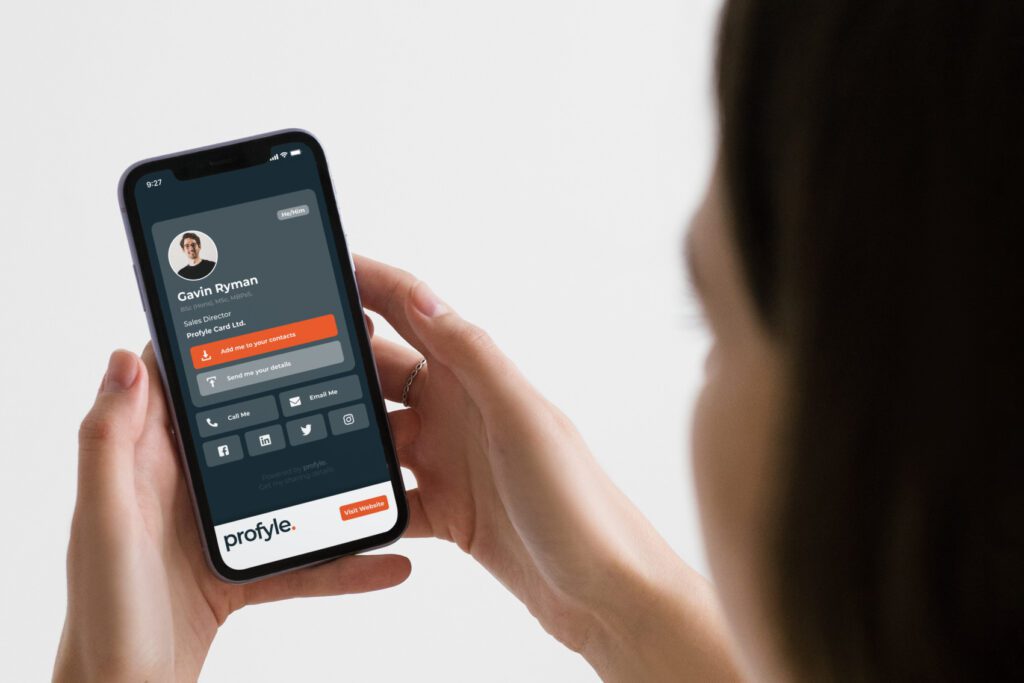 Hands holding a smartphone displaying a digital business card for Gavin Ryman with contact details and the Profyle logo.