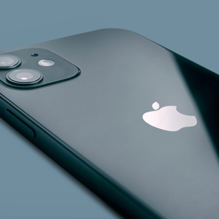 Back of a dark smartphone with a dual camera system and a white Apple logo.