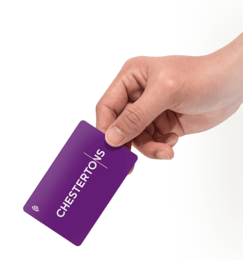 Hand holding a purple card with 'CHESTERTONS' text and a wireless symbol